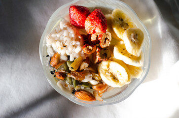 Homemade yogurt topped with sauce, fresh fruit and lots of grains.