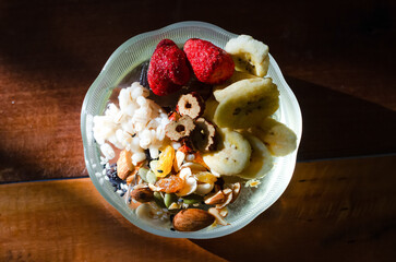 Homemade yogurt topped with sauce, fresh fruit and lots of grains.