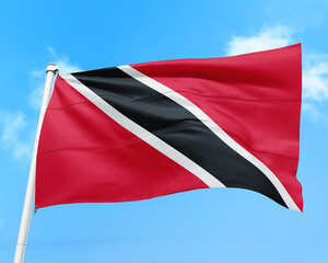 Trinidad and Tobago flag fluttering in the wind on sky.