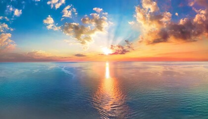 aerial panoramic view of sunset over ocean colorful sky clouds water beautiful serene scene wide angle seascape drone view majestic stunning nature background best sea sky sunrise inspire views - Powered by Adobe