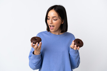 Young caucasian woman isolated on white background holding donuts with happy expression