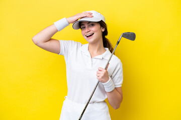 young caucasian woman playing golf isolated on yellow background smiling a lot