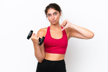Young sport caucasian woman making weightlifting isolated on white background showing thumb down with negative expression
