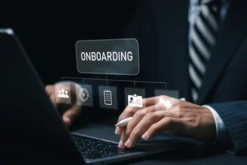 Fotobehang Onboarding business process concept. Businessman use laptop with virtual onboarding icon for making sure new employees can hit the ground running with their new team. © Pakin