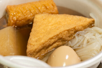 Oden - a Japanese winter food served in a styrofoam bowl from the convenience store in Japan. Close up shot.