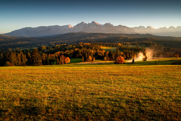 View on Tatra peaks from Łapszanka. Podhale, Poland. Golden hour in the countryside.