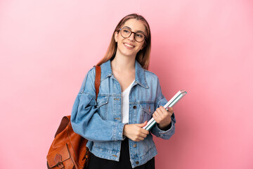 Young caucasian student woman isolated on pink background thinking an idea while looking up