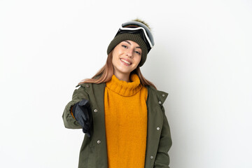 Skier caucasian woman with snowboarding glasses isolated on white background shaking hands for closing a good deal