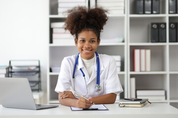 Portrait of an African medical student doing an internship in an office at a hospital.
