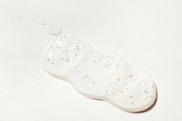 Close up of transparent serum or oil on light background