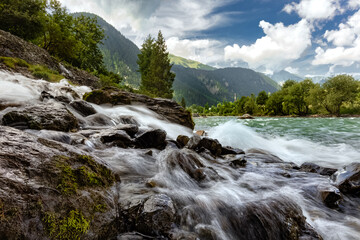 River in the mountains. The beautiful river flowing between alpine meadows of Parvati valley in the...