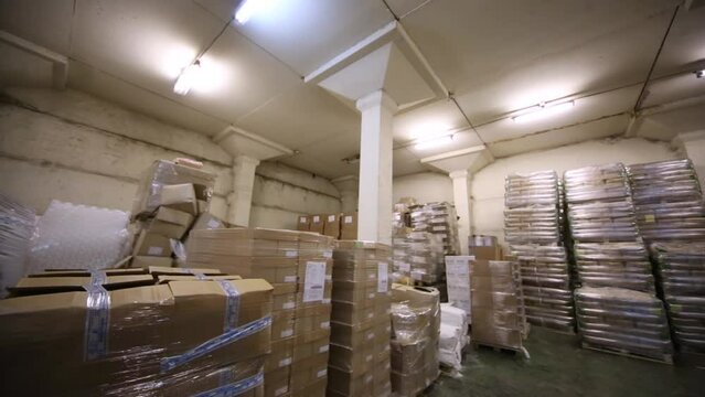 The room of warehouse filled with boxes and pallets.