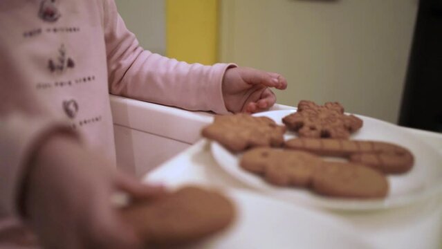 Cute Little Girl Decorates Gingerbread