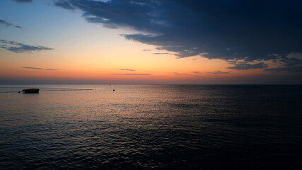 Obraz premium Landscape by the sea in Greece on the island of Rhodes. Sunrise, dramatic clouds. Beautiful background.