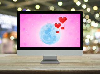 Red fabric heart love air balloon fly over moon and blur pink star background on computer monitor...
