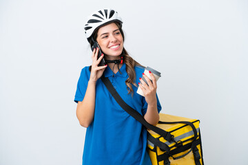 Young delivery woman with thermal backpack isolated on white background holding coffee to take away and a mobile