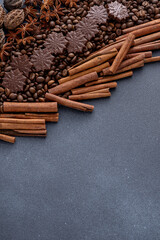 Food background. Coffee beans, cinnamon sticks, anise stars and chocolate candies top view. Copy space