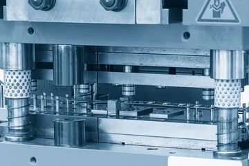 The metalworking process by progressive die in the light blue scene.