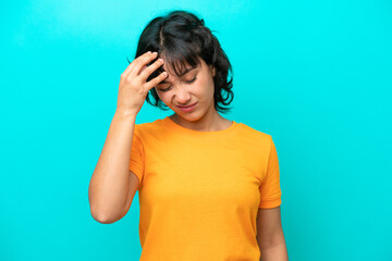 Young Argentinian woman isolated on blue background with headache