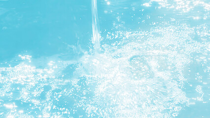 spakling water surface with water stream in sunshine, turquoise water background with glittering...