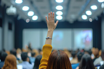 Photo of people asking questions or making presentations, journalists raising their hands in the audience