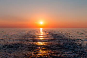 Sea sunset with ship trace