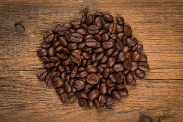 Coffee beans on grunge wooden background