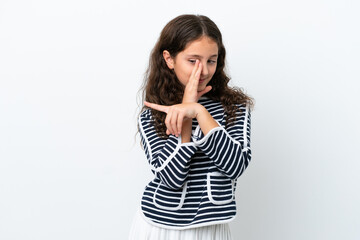 Little caucasian girl isolated on white background pointing to the side to present a product and whispering something