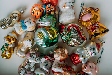 Christmas shaped glass toys in a box. Toys in the form of animal symbols of the year: dragon, monkey, cat, sheep, dog, bull, mouse, pig, tiger, rooster. Toys for the Christmas tree