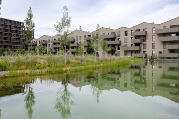 The house, stylized as a townhouse, is reflected in the clear water of the canal