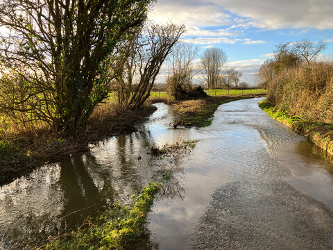 Stream and flooded country lane after heavy rain, Somerset