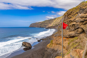 Warning red flag on the beach in Tenerife dangerous Atlantic Ocean