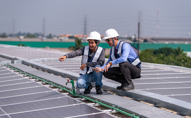 Engineers walking on roof inspect and check solar cell panel by hold equipment box and radio communication ,solar cell is smart grid ecology energy sunlight alternative power factory concept	