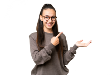 Young Arabian woman over isolated chroma key background holding copyspace imaginary on the palm to insert an ad