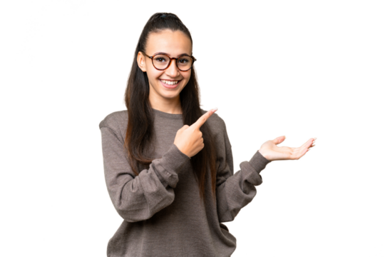 Young Arabian woman over isolated chroma key background holding copyspace imaginary on the palm to insert an ad