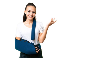 Young Arabian woman with broken arm and wearing a sling over isolated chroma key background...