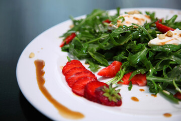 Salad with arugula, cream cheese and strawberries. Salad with arugula and strawberries. Rucola and strawberries.