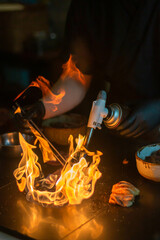Grill meat with torch by chef, fire 