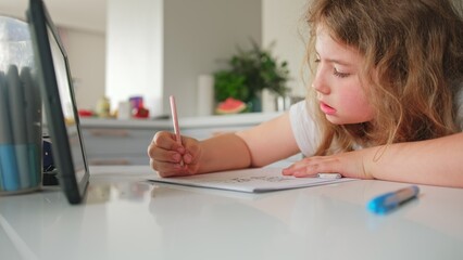 Cute Caucasian Girl Primary School Student Doing Homework using Tablet