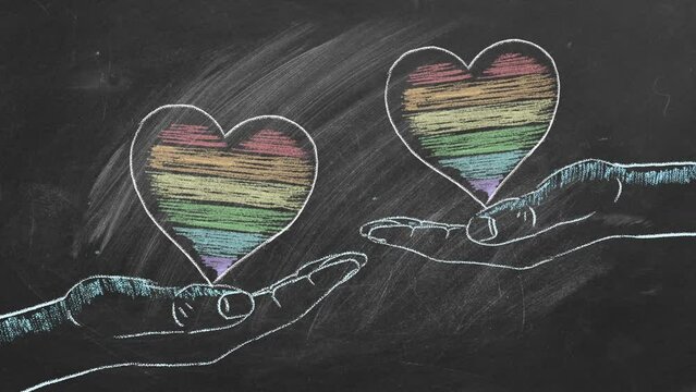 Two male hands with rainbow hearts. LGBT, LGBTQIA rights and gender equality concept. Pride month. Declaration of love, acceptance of feelings, giving love.