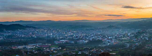 Panorama view of the skyline of the Galician city of Ourense at dusk as seen from the outskirts. - 709056881