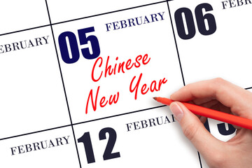 February 5. Hand writing text Chinese New Year on calendar date. Save the date.
