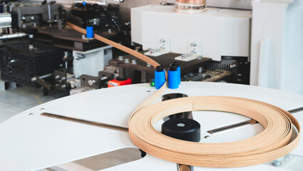 Wood boards on a woodworking machine in a modern furniture factory, woodworking industrial concept background