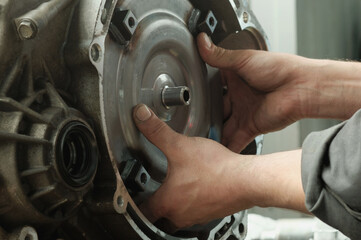 Repair of an automatic transmission at a car service station. The torque converter is in the hands...