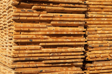 Wooden timber at a sawmill. Piles of wooden boards in the sawmill. Industry