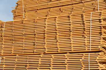 Stack of fresh pine boards in a sawmill warehouse. Stacks of lumber