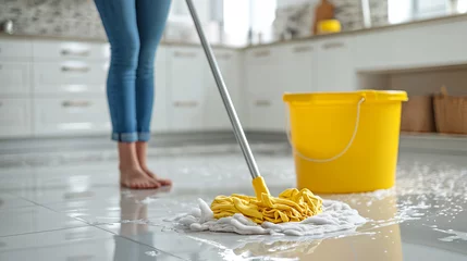Foto op Aluminium Young woman cleaning the white floor in the kitchen with a wet mop at home, copy space. unchanging concept of hygiene, bucket and lifestyle © Katrin_Primak
