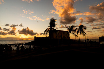 Naklejka premium View of the Fort of Santa Maria, in silhouette, at Porto da Barra in the city of Salvador, Bahia.