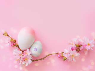 Fototapeta na wymiar easter eggs and cherry flowers on a pink background with bokeh and copy space. Church Christian holidays, Christianity, Easter background