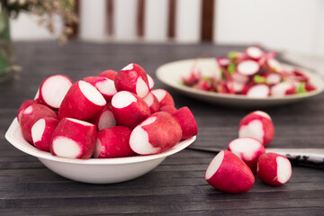 Cooked crispy radish in white bowl on wooden table